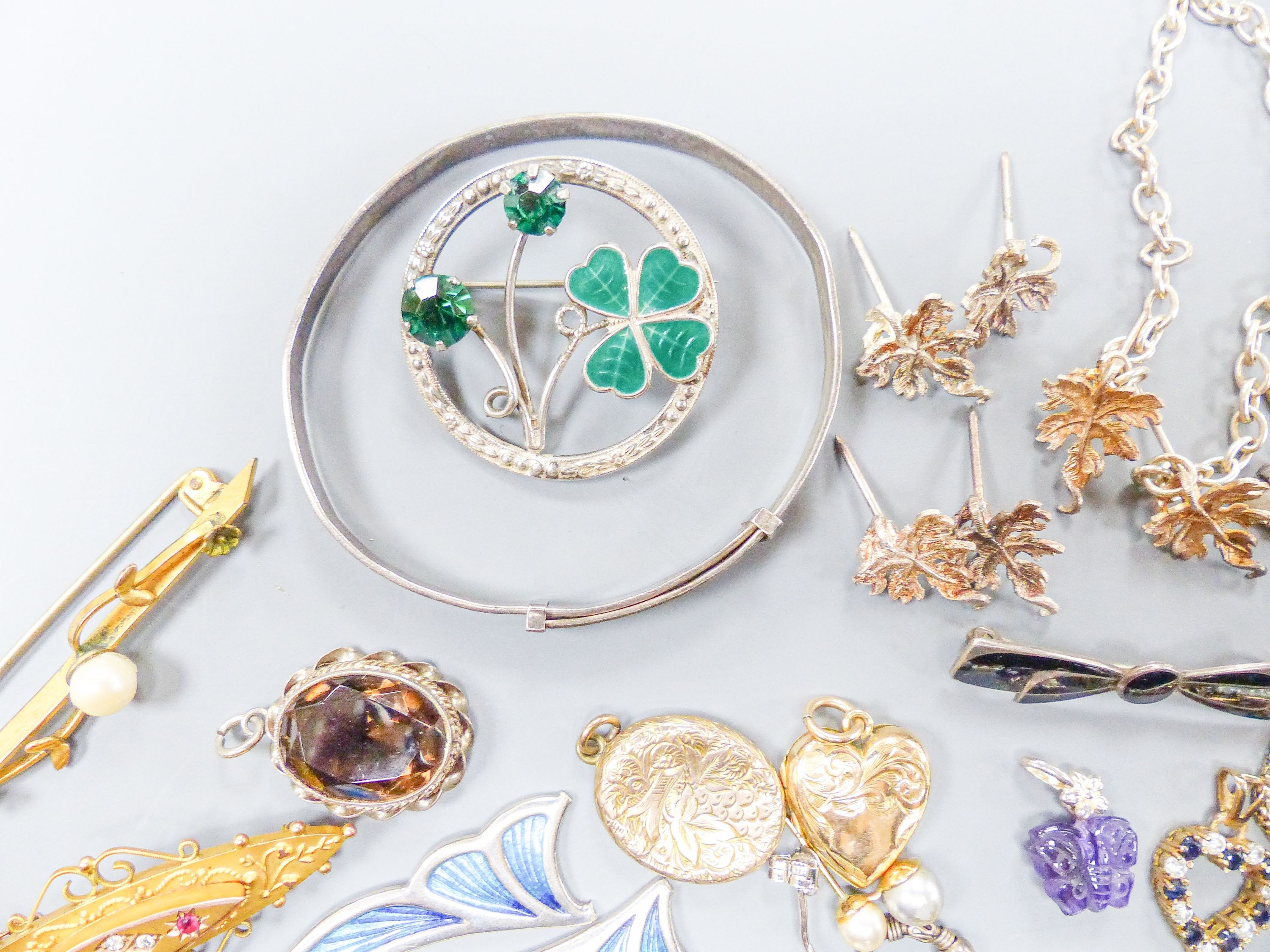 Assorted gold and silver jewellery including bar brooches, charm bracelet etc.